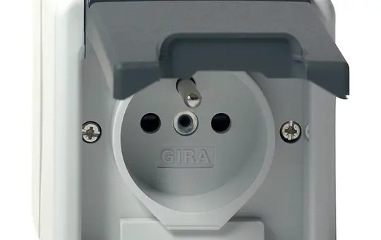 GIRA 448530 International Socket Surface-Mounted IP44 FR/BE, touch protection, hinged lid, without claws | gray